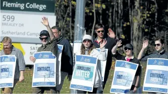  ?? CLIFFORD SKARSTEDT/EXAMINER ?? Academic staff at Fleming College wave to motorists as they march the picket line on Friday at the Sutherland Campus on Brealey Drive. Ontario Public Service Employees Union (OPSEU) Local 352 went on strike Monday. Local 352 represents about 250...