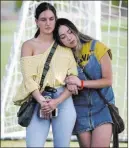  ??  ?? Ashlee Hawley, right, one of Brooke Hawley’s older sisters, hugs friend Alana Maurer during Tuesday’s news conference.