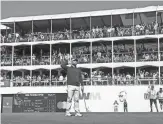  ?? ROB SCHUMACHER/THE REPUBLIC ?? Jon Rahm reacts as the gallery roars after he made his birdie putt on the 16th green on Friday at TPC Scottsdale.