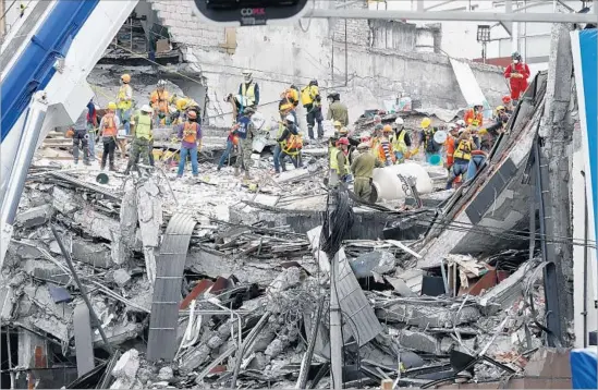  ?? Photograph­s by Gary Coronado Los Angeles Times ?? RESCUE WORKERS Sunday continue to search for victims in the ruins of a fallen office building in Mexico City’s Condesa district after last week’s 7.1 earthquake.