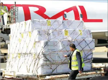  ?? MOHAMMED HUWAIS/AFP ?? A technician unloads doses of vaccines from a plane after it landed in the rebel-held Yemeni capital Sanaa on Saturday.