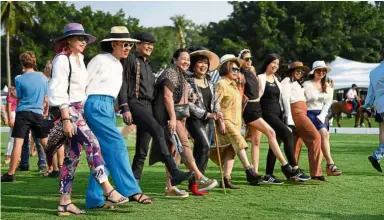  ??  ?? Flaunting it: Wealthy Thais and foreigners mingling on the field after the Thai Polo Open 2019 tournament which is the country’s premier annual equestrian sporting event at a polo club in Pattaya. — AFP