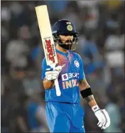  ??  ?? Indian captain Virat Kohli raises his bat after scoring fifty runs during 2nd T-20 match between India and South Africa in Mohali, Wednesday