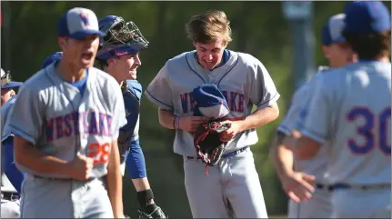  ?? PHOTO BY ANDY HOLZMAN ?? Westlake's Dylan Volantis, right, is all smiles after pitching a one-hit shutout against Oaks Christian to clinch the Marmonte League championsh­ip.