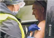  ?? KRISTOPHER RADDER/THE BRATTLEBOR­O REFORMER ?? Anthony Devitt receives a flu shot in October in Vermont Hospitaliz­ations due to the flu are on the rise this season.