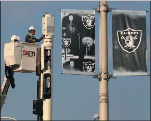  ?? PHIL MASTURZO/AKRON BEACON JOURNAL ?? Workers prepare for the upcoming NFL Draft on April 7 near the location of the main stage behind FirstEnerg­y Stadium in Cleveland.