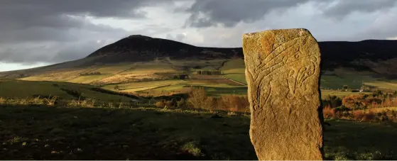  ??  ?? Rhynie Man (left) and the Craw Stane (above, both c 1.8m tall), may have stood together at the entrance to a defended enclosure revealed in air photos and recent excavation­s (bottom)