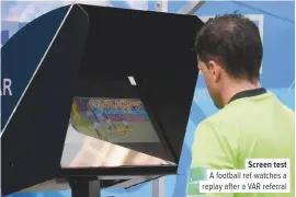  ??  ?? Screen test A football ref watches a replay after a VAR referral