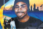  ?? Jessica Christian / The Chronicle ?? Wanda Johnson (right), mother of the late Oscar Grant, at the mural unveiling honoring her son.