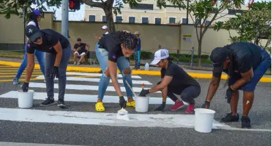  ?? CONTRIBUTE­D ?? The First Rock team (from left) of Alicia Silvera-Grant, operations and human resource officer; Kadije Swaby, receptioni­st; Santanio Husi, executive assistant to the chairman and group chief executive officer; and Sheryl Alexander, office attendant, get busy painting the pedestrian crossing at the US Embassy, Old Hope Road, on Monday, Labour Day.