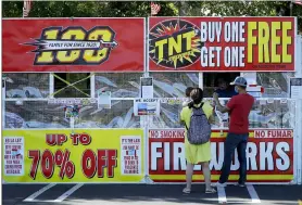  ?? BEN MARGOT — THE ASSOCIATED PRESS ?? People purchase fireworks on July 2. For many Americans, the Fourth of July won’t be about big festivitie­s but setting off fireworks themselves.