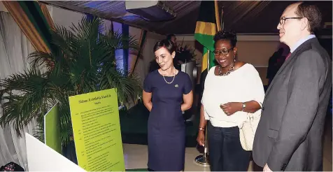  ??  ?? Minister of Foreign Affairs and Foreign Trade Kamina Johnson Smith (left), Director of Public Prosecutio­ns Paula Llewellyn, and Chargé D’Affaires of the High Commission of South Africa, Phillip Riley, look at a written time capsule of the life of...