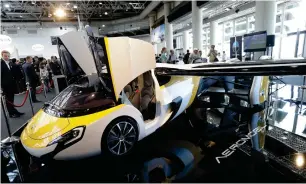  ?? AP ?? AeroMobil displaying its latest prototype of a flying car in Monaco on Thursday. The light frame plane whose wings can fold back, like an insect is boosted by a rear propeller. The company says it is planning to accept first preorders for the vehicle...