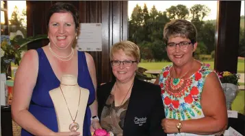  ??  ?? Margaret Moore receiving her first prize from lady Captain Siobhán Moore and Vice-Captain Joanne Kenny as winner of the Bunclody Golf and Fishing Club lady Captain’s day held on July 2.