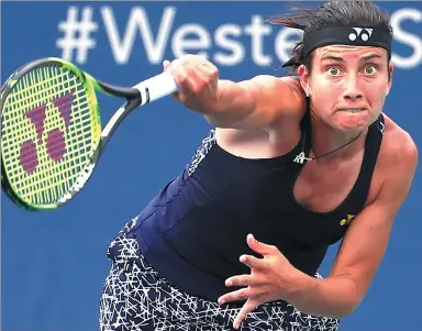  ?? JOHN MINCHILLO / AP ?? Latvia’s Anastasija Sevastova leans into a serve in her 6-4. 6-3 loss to Simona Halep of Romania during the round of 16 of the ATP/ WTA Cincinnati on Thursday.