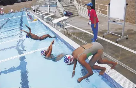  ?? Photograph­s by Mel Melcon
Los Angeles Times ?? THE CUBAN DELEGATION’S swimmers practice in Harvard-Westlake High School’s pool. Two had forgotten their goggles and swim caps that morning, so a woman from the school offered them black goggles and caps emblazoned with the U.S. f lag.