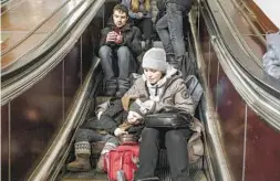  ?? EMILE DUCKE NYT ?? Anna Hayko and her son, Vladislav, shelter in a subway station in Kyiv, Ukraine, on Friday as Russia slammed Ukraine’s already battered infrastruc­ture.