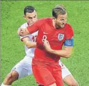  ?? AFP ?? Tunisia's Ellyes Skhiri (L) tackles England captain Harry Kane.