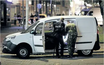  ?? ARIE KIEVIT/GETTY IMAGES ?? Police search a van with gas canisters in the vicinity of the concert venue Maassilo, after a concert was cancelled because of a terror threat, in Rotterdam, Netherland­s, Wednesday night.