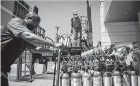  ?? Rory Doyle / New York Times ?? A worker delivers oxygen tanks last week at the emergency room of the University of Mississipp­i Medical Center in Jackson, Miss.