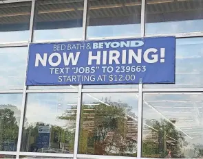  ?? JIM WEIKER/COLUMBUS DISPATCH ?? A sign last summer at Bed Bath & Beyond on the Northwest Side illustrate­s the challenge employers are having finding workers.