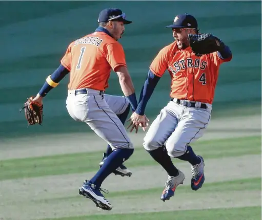  ?? Photos by KarenWarre­n / Staff photograph­er ?? Carlos Correa, left, and George Springer might as well jump after the final out of the Astros’ Game 2 win over the Athletics at Dodger Stadium. Springer drove in three runs with a pair of homers, giving him 17 for his career in the postseason to land in a four-way tie for seventh overall.