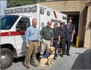  ?? PHOTO COURTESY AARON DURSO ?? Birdsboro Borough Manager Aaron Durso, second from left, took his new seizure response service dog Dexter to meet members of Southern Berks EMS. Durso suffers from a seizure disorder and wanted his new service dog to meet first responders.