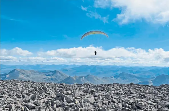  ?? ?? UP, UP AND AWAY: The moment captured on film when the mystery daredevil launched himself off the summit of Ben Nevis to make his descent.