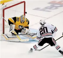  ?? GENE J. PUSKAR THE ASSOCIATED PRESS FILE PHOTO ?? Penguins goaltender Matt Murray, pictured in a one-on-one battle with Chicago’s Brandon Saad on Nov. 9, 2019, says he’s focusing on the NHL’S return to play, not the potential economic ramificati­ons on the league due to the COVID-19 pandemic.