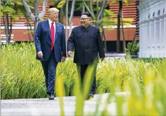  ?? DOUG MILLS / NEWYORK TIMES ?? President Donald Trump (left) andNorth Korean leader KimJongUnw­alk after lunch Tuesday on Sentosa Island in Singapore. Trumpcalle­d the talks “honest, direct and productive.” ByGregBlue­stein
