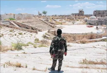  ?? Nabih Bulos For The Times ?? A SOLDIER keeps watch from the Citadel of Aleppo, a towering ancient fort complex that arises from the Old City and provides a panoramic view of both opposition and government-held areas.