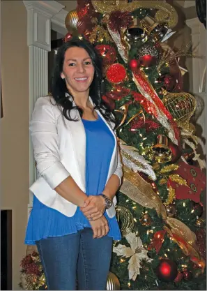  ?? SAM PIERCE/TRILAKES EDITION ?? Nikki Weatherly poses in front of her Christmas tree inside her house in Benton. Weatherly is chairing the annual charity ball for the Junior Auxiliary of Saline County. The event will be at 7 p.m. Jan. 27 at the Benton Event Center. Tickets for the...