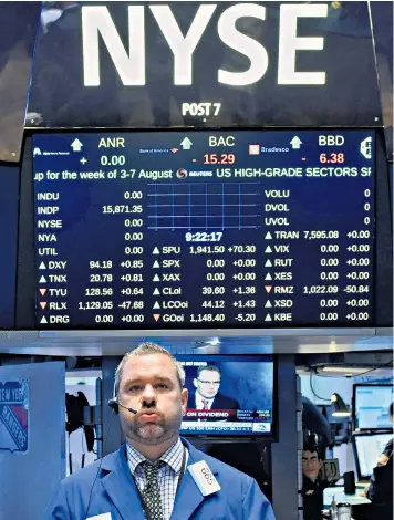  ??  ?? A trader on the floor of the New York Stock Exchange yesterday. US stocks joined in the rally, buoyed by hopes for a delay to rate rises