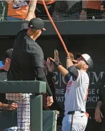  ?? KENNETH K. LAM/STAFF ?? Cowser drinks from the homer hose after going deep in the eighth inning Sunday against the Brewers.