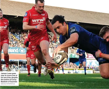  ?? SEB DALY/SPORTSFILE ?? James Lowe goes over to score one of his two tries despite the tackle of Corey Baldwin of Scarlets