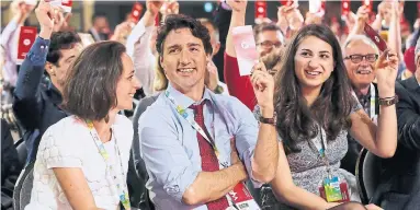  ?? JOHN WOODS/THE CANADIAN PRESS FILE PHOTO ?? Prime Minister Justin Trudeau sits with Liberal party president Anna Gainey, left, and Liberal youth president Mira Ahmad at the 2016 Liberal convention in Winnipeg. The youth vote was crucial to getting Trudeau elected.