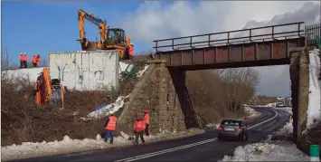  ??  ?? A crew working to repair the damage to the railway line near Inch.