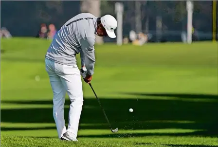  ?? CHARLIE RIEDEL/AP PHOTO ?? Haotong Li of China hits from the fairway on the ninth hole during the second round of the PGA Championsh­ip on Friday at TPC Harding Park in San Francisco. Li was the early second-round leader at 8-under. Visit www.theday.com for a complete recap.