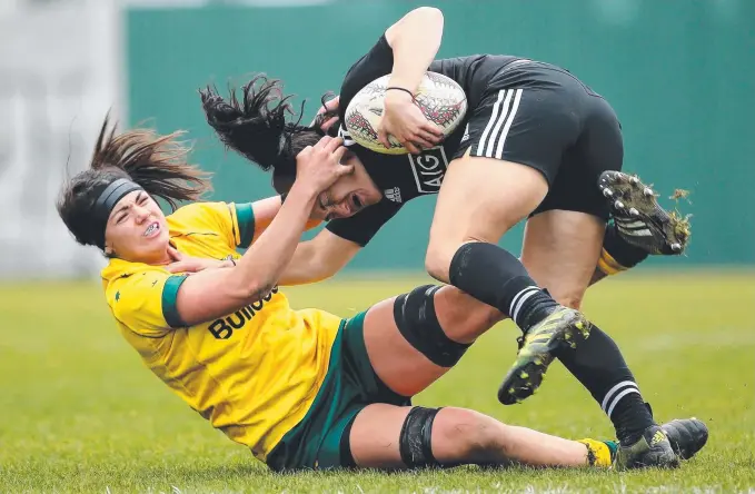  ?? Picture: GETTY IMAGES ?? Wallaroos star Millie Boyle brings down New Zealand rival Portia Woodman in a Four Nations Test in Christchur­ch.