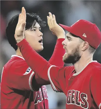  ?? AP PHOTO/DAVID J. PHILLIP ?? Los Angeles Angels’ Shohei Ohtani (left) and Jared Walsh celebrate after a baseball game against the Houston Astros on Sunday in Houston. The Angels won 2-1.