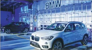  ?? HAO YAN / CHINA DAILY ?? The BMW X1 xDrive 25Le and i3 electric vehicles are displayed at the new BMW China R&D Center in Beijing. The center plans to run 72 test vehicles across China.