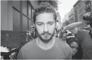  ?? JOHN MINCHILLO/ THE ASSOCIATED PRESS ?? In hot water again: Actor Shia LaBeouf leaves court in New York on Friday after his arrest the previous day for shouting obscenitie­s during the Broadway show Cabaret.
