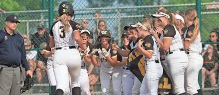  ?? KURT SNYDER/THE ADVOCATE ?? Watkins Memorial players celebrate Mckayla Jellison's solo home run during a 6-1 victory against Mount Vernon in a Division I district final Friday at Pickeringt­on Central.