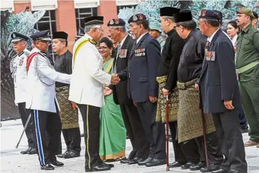  ??  ?? Honouring the heroes: Najib shaking hands with veterans of F-Team, the elite unit of the Special Branch responsibl­e for ending the communist terrorist era in Malaysia at Dataran Pahlawan in Putrajaya. With him is Fuzi (left).