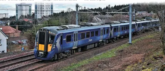  ?? NIGEL CAPELLE. ?? ScotRail 385112 accelerate­s away from Falkirk High on February 7. Hitachi is building 70 of these EMUs for SR, and has confirmed they could be converted to batterypow­er, or the Japanese company could build new battery-powered ‘385s’.