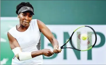  ?? HARRY HOW/GETTY IMAGES/AFP ?? Venus Williams hits a backhand in her win over Jelena Jankovic during the BNP Paribas Open at Indian Wells Tennis Garden on Saturday in California.