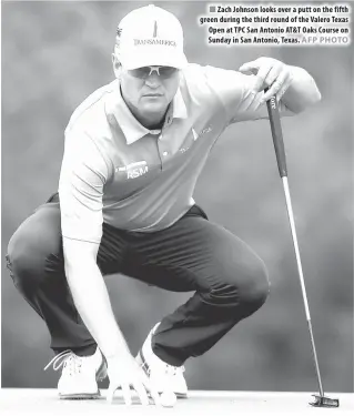  ?? AFP PHOTO ?? Zach Johnson looks over a putt on the fifth green during the third round of the Valero Texas Open at TPC San Antonio AT&T Oaks Course on Sunday in San Antonio, Texas.