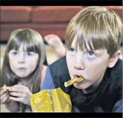  ??  ?? The horror: Kids depicted watching Donald Trump on TV in a Clinton ad.