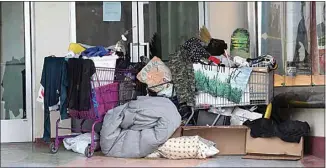  ?? ALEX HORVATH / THE CALIFORNIA­N ?? Homeless people shelter from the rain at the Fox Theater in this April file photo.