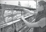  ?? VALENTYN OGIRENKO / REUTERS ?? An employee sorts Danone dairy products at a Metro cash and carry store in Kiev, Ukraine.